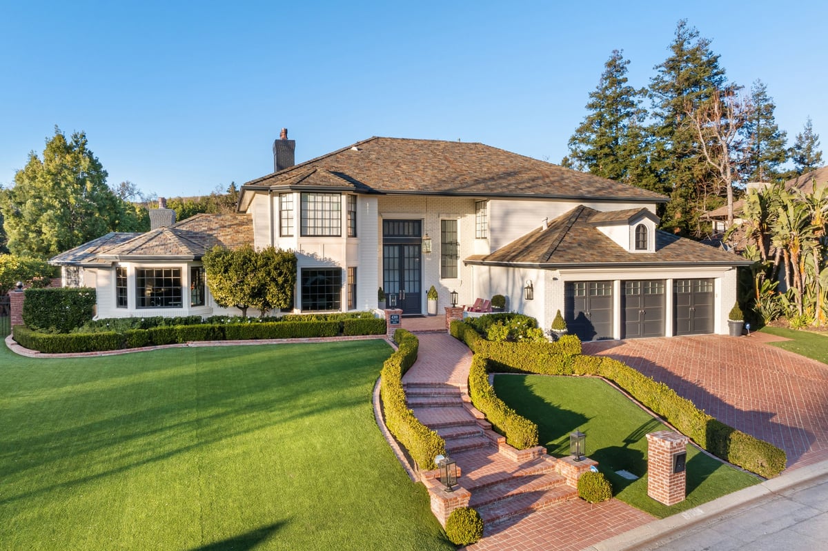Luxury estate with manicured lawn and grand entrance